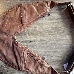 Brown Studded Bag: hold close to your body during travel or locally. Leather.
